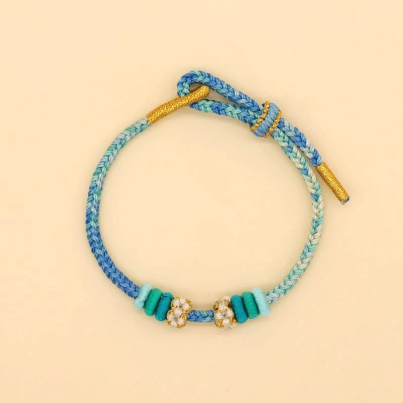 Handcrafted eight-thread peace knot lucky bracelet showing traditional Tibetan braiding technique and construction