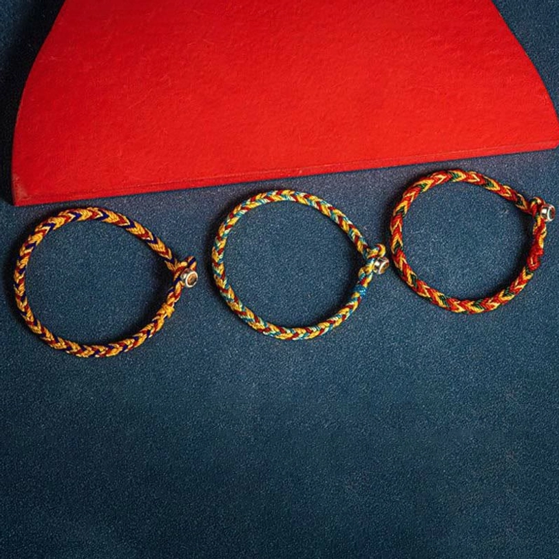 Set of three Tibetan braided protection bracelets with gold accents showing intricate weave detail