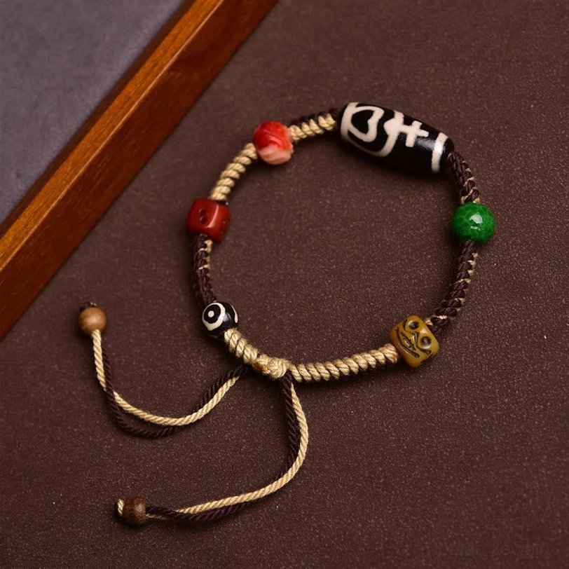 Sacred Tibetan dzi bead bracelet circular layout with multi-color decorative beads and protective amulet design