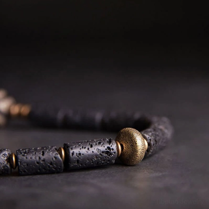 Handmade tibetan three-eye dzi lava rock bracelet artisan craftsmanship detail - natural stone variations and quality