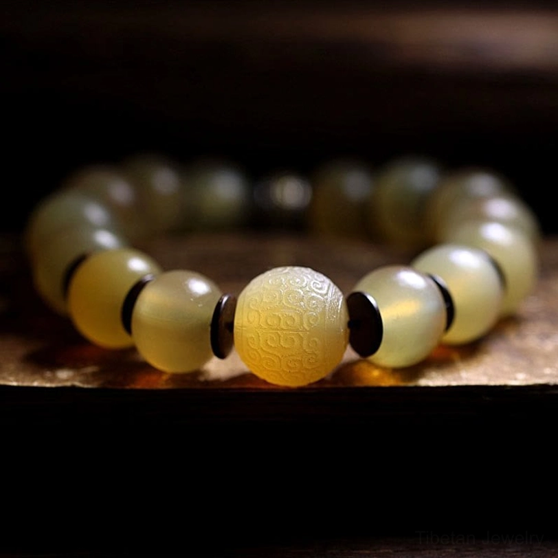 Handmade Tibetan sheep horn bracelet close-up showing large matte carved bead with metal spacer rings