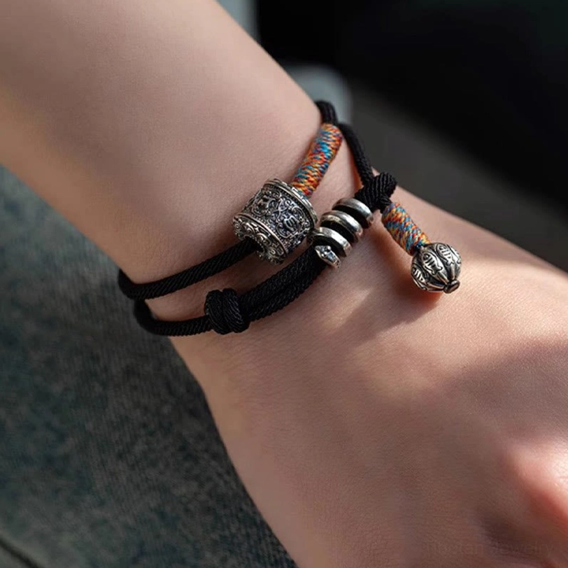 Handmade Tibetan mantra bracelet showing authentic artisanal craftsmanship and carved sacred symbols