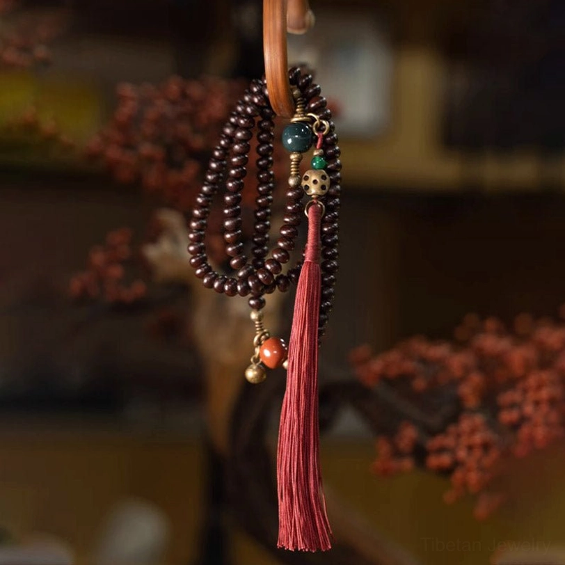 Hanging tibetan bodhi seed mala bracelet displayed as spiritual décor ornament