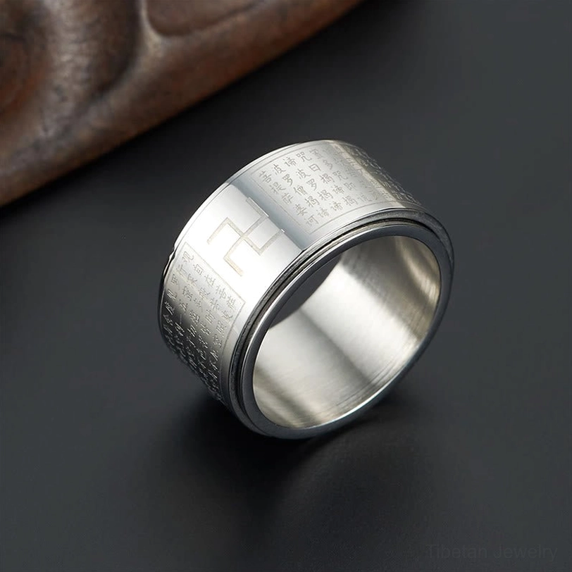 Heart Sutra Swastika Ring detail shot showing rotatable band mechanism and laser-engraved text clarity