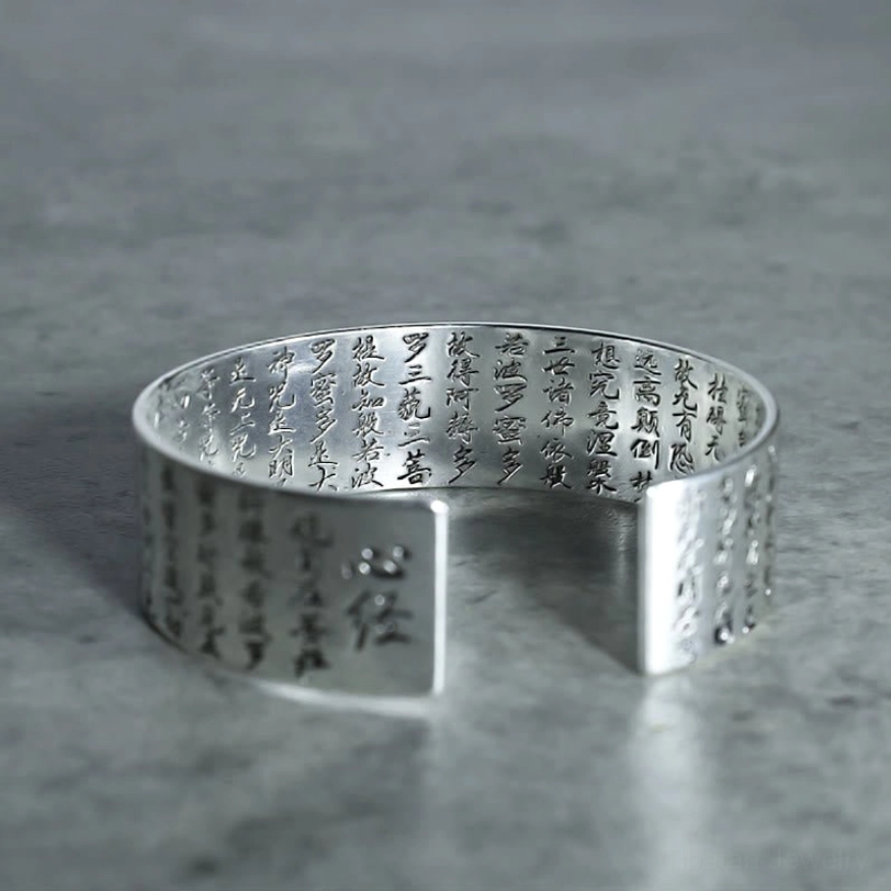 Heart Sutra silver copper cuff bracelet close-up front view showing full sacred sutra engraving and polished metal surface