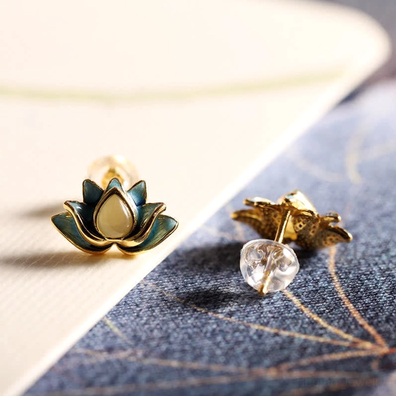 Pair of Hetian cyan jade lotus studs showing front and back design on textured paper background, sterling silver construction detail
