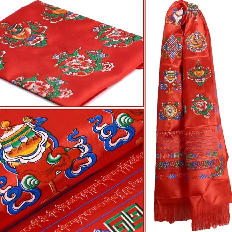 Close-up macro detail of blue Tibetan khata showing intricate dharma motifs and smooth satin surface texture