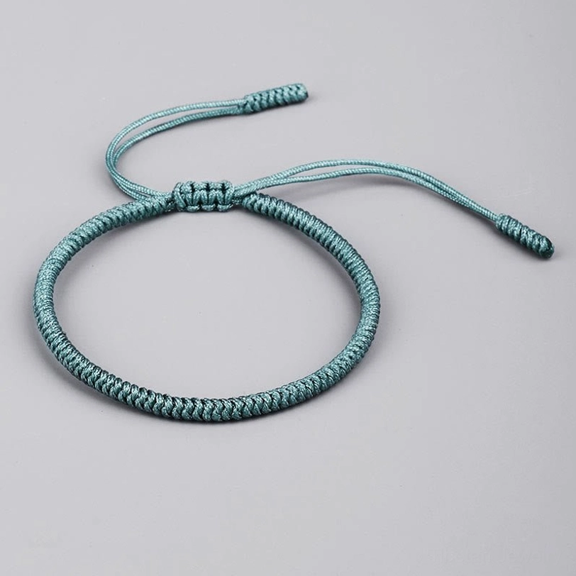 Single teal King Kong knot protection bracelet with long adjustable braided cord ends