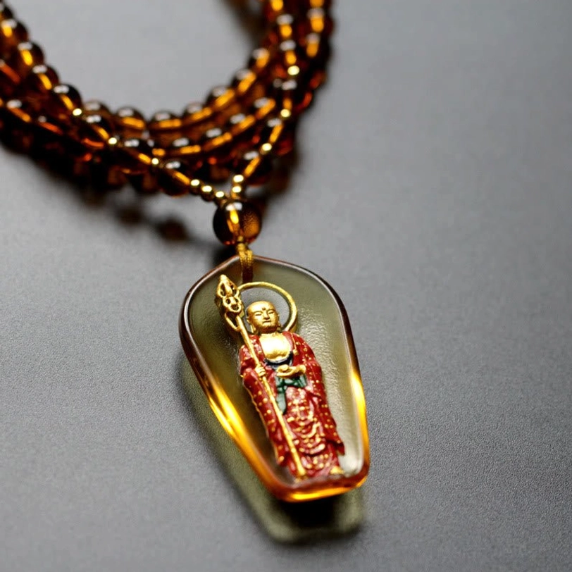 Brown red beaded strand Ksitigarbha Buddha necklace with amber Liuli crystal trapezoidal pendant and gilded standing figure