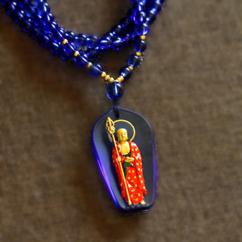 Dark sapphire Ksitigarbha Buddha Liuli crystal pendant with standing gilded bodhisattva and blue beaded chain necklace