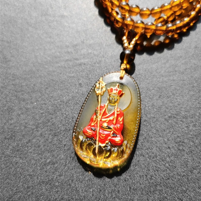 Classic yellow Ksitigarbha Buddha Liuli crystal necklace featuring seated bodhisattva with gilded details and beaded chain