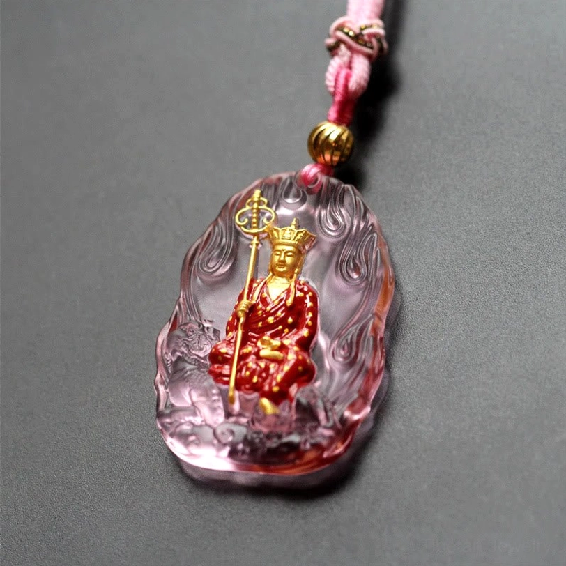 Rose pink Ksitigarbha Buddha Liuli crystal pendant with flame border, seated gilded bodhisattva figure, and pink braided cord