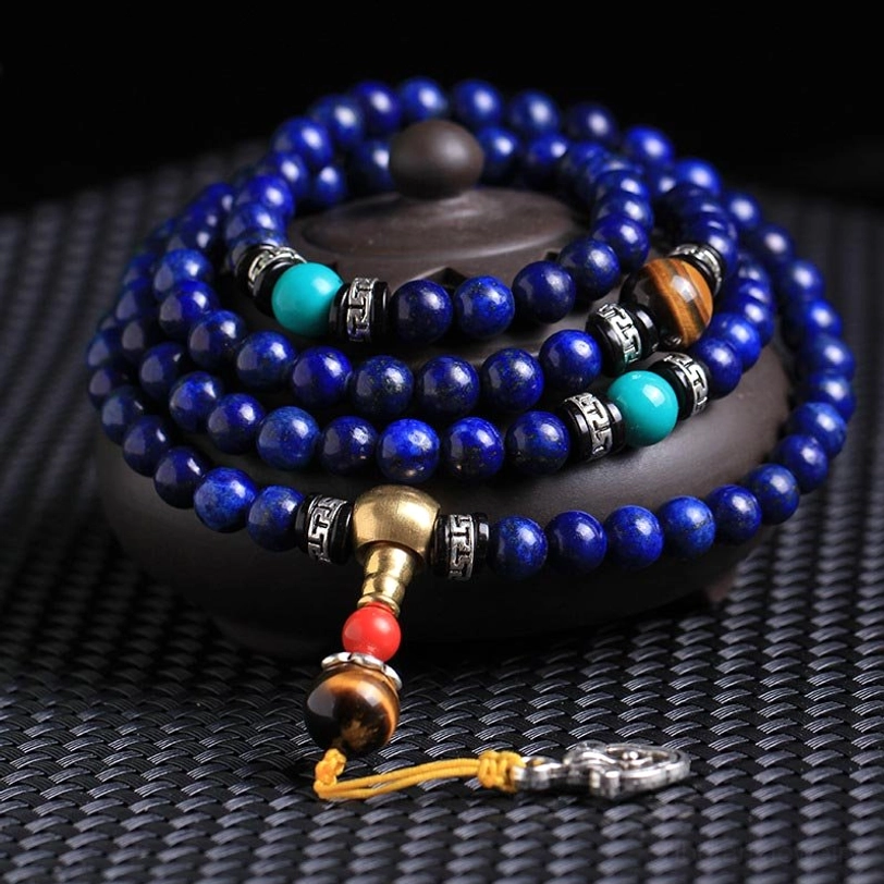 108-bead Lapis Lazuli Tibetan mala bracelet with tiger eye and turquoise gemstones overhead close-up view