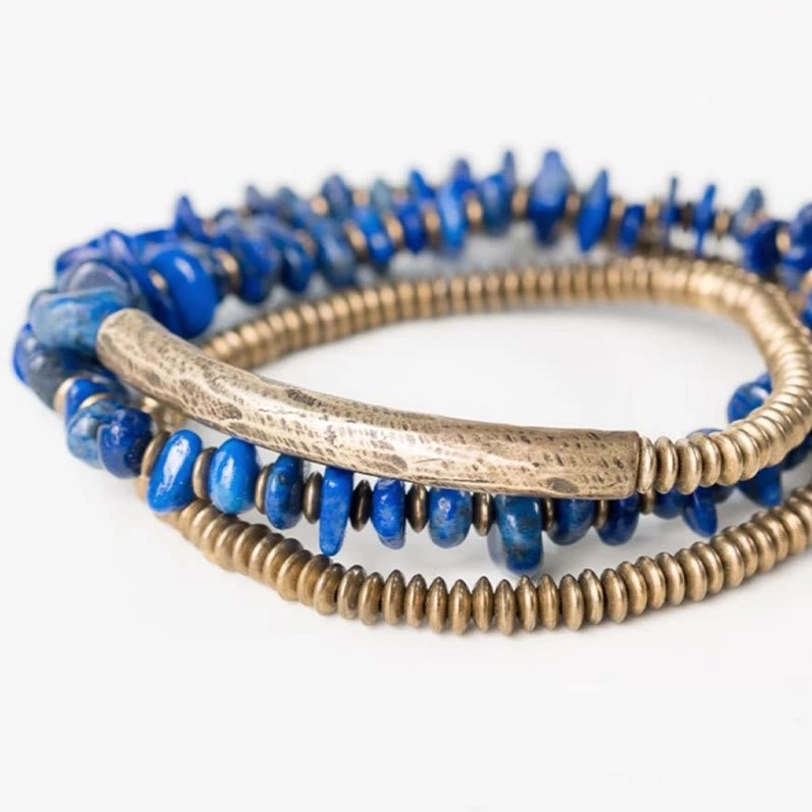Close-up detailed view of lapis lazuli triple wrap bracelet showing individual chips, brass hardware and layers