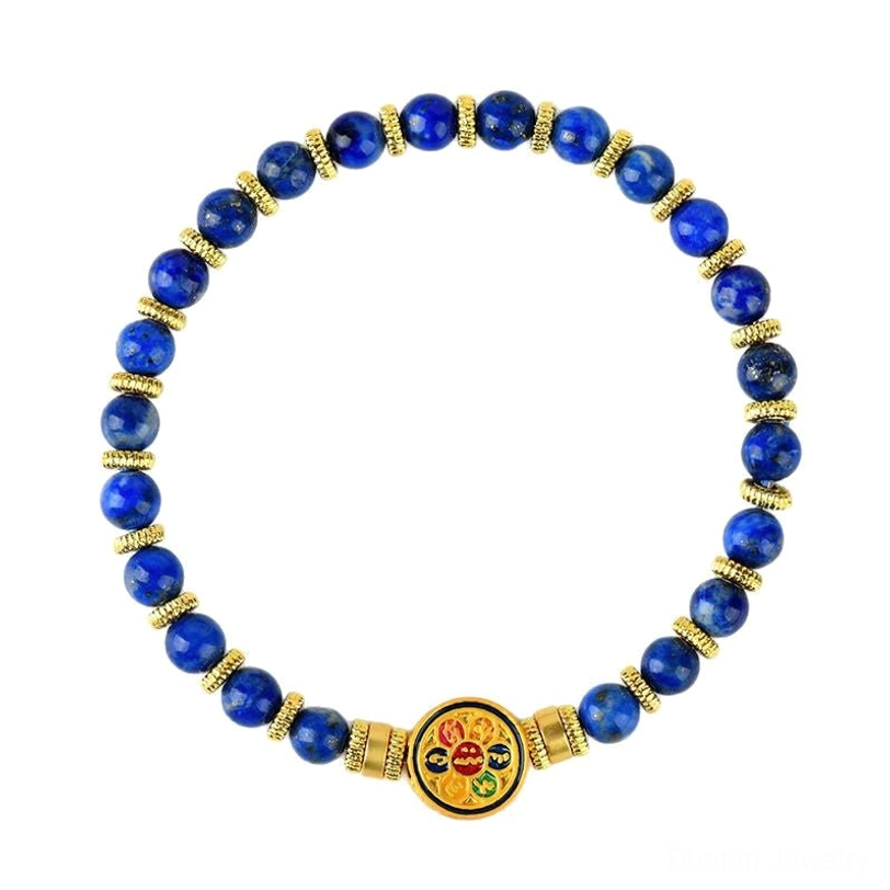 Lapis lazuli stretch bracelet with variegated blue stone beads, gold spacers and enamel medallion flat lay