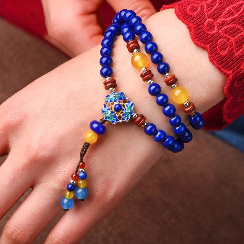 Handcrafted multi-layer Lapis Lazuli Yellow Agate bracelet side profile showing enamel flower charm and dangling tassel