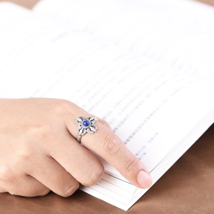 Lapis lazuli sterling silver ring worn on index finger in casual lifestyle setting