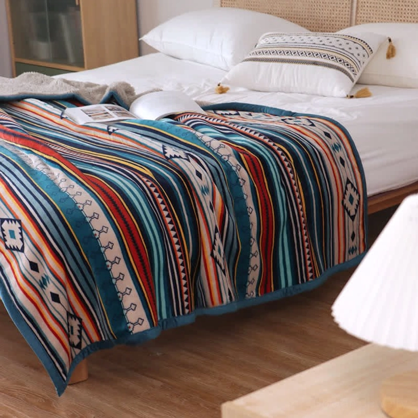 Large size Tibetan geometric throw blanket 150x200cm displayed on queen bed with bohemian tribal print and sherpa lining