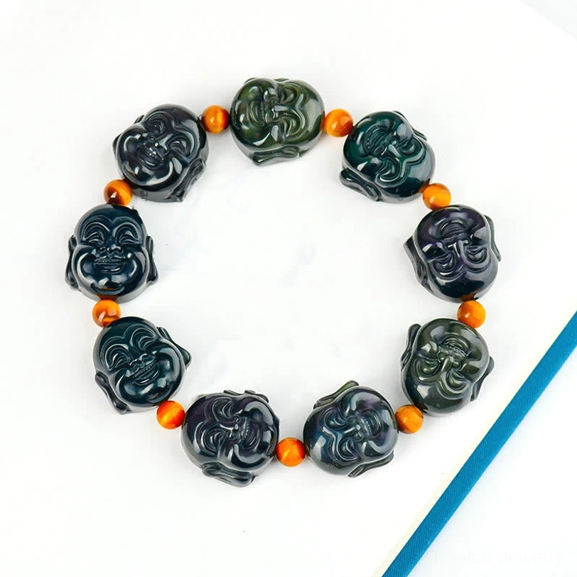Laughing Buddha obsidian bracelet top view - complete strand on plain notebook showing full bead design and rainbow iridescent surface