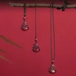 Laughing Buddha cinnabar hanging ornament set displayed on red background with multiple rope length options