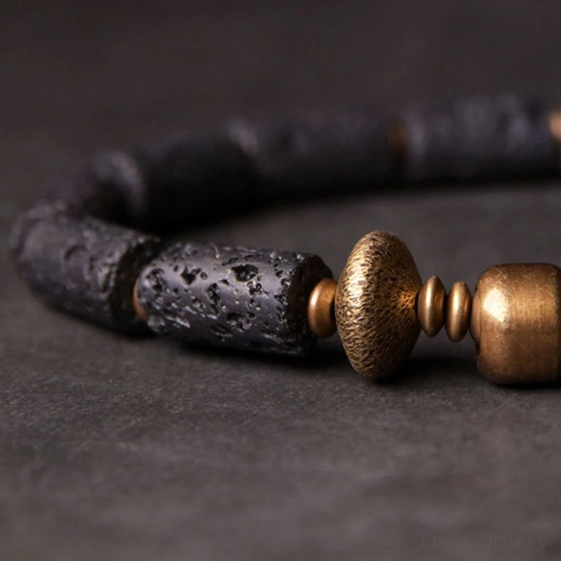 Lava rock bracelet highlighting flat disc copper spacer beads and natural stone texture from low angle