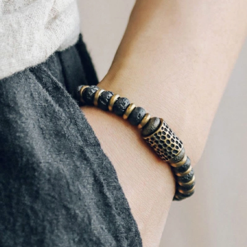 Lava rock copper bracelet worn on wrist with denim background showing daily wear styling