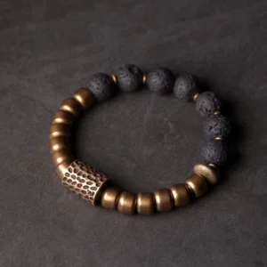 Lava rock and brass healing bracelet with etched metal spacer, flat lay top-down view