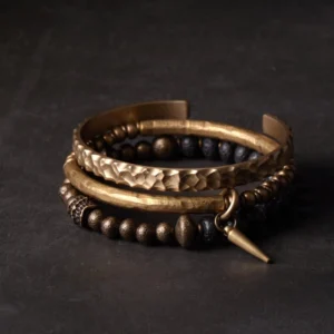 Three piece lava rock and brass bracelet stack - top view flat lay showing volcanic stone beads and bronze metal spacers