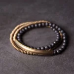 Grounding lava rock and copper healing bracelet in multiple sizes - black volcanic beads with antiqued brass components displayed