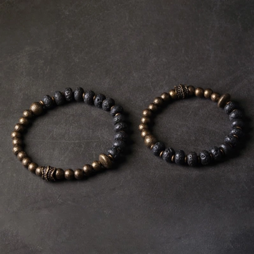 Two lava rock copper bracelets displayed flat lay showing full circle design with mixed lava and bronze metal beads