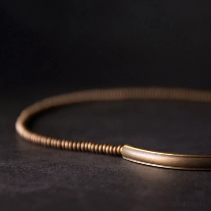 Minimalist vintage copper coil necklace with lava rock bead accent in grounding jewelry collection