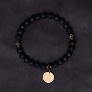 Full circle view of lava rock grounding bracelet with copper charm and elastic band, demonstrating complete design from above