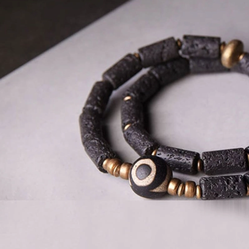 Stacked double wrap dzi lava rock bracelets close-up side angle - layered design showing porous volcanic stone texture