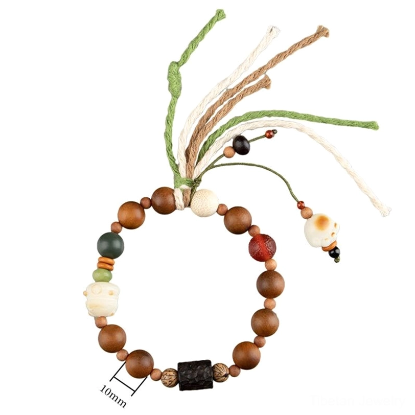 Lightning strike wood bodhi bracelet with protective cat paw charm showing Tibetan Buddhist craftsmanship and natural material texture