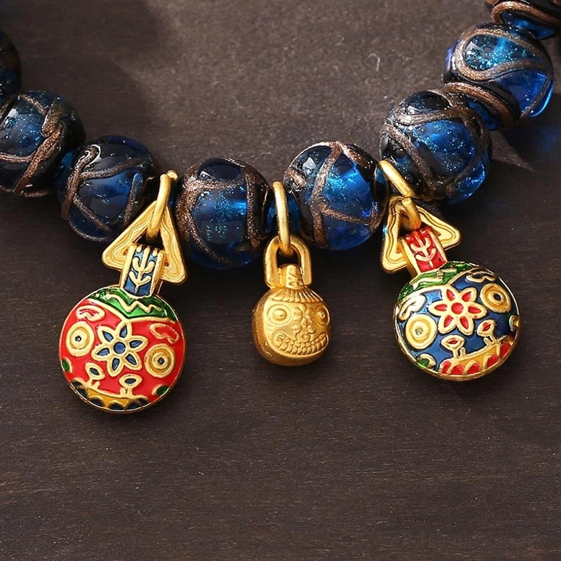 Close-up detailed view of blue Liuli glass beads and gold-plated copper hardware of prosperity bracelet
