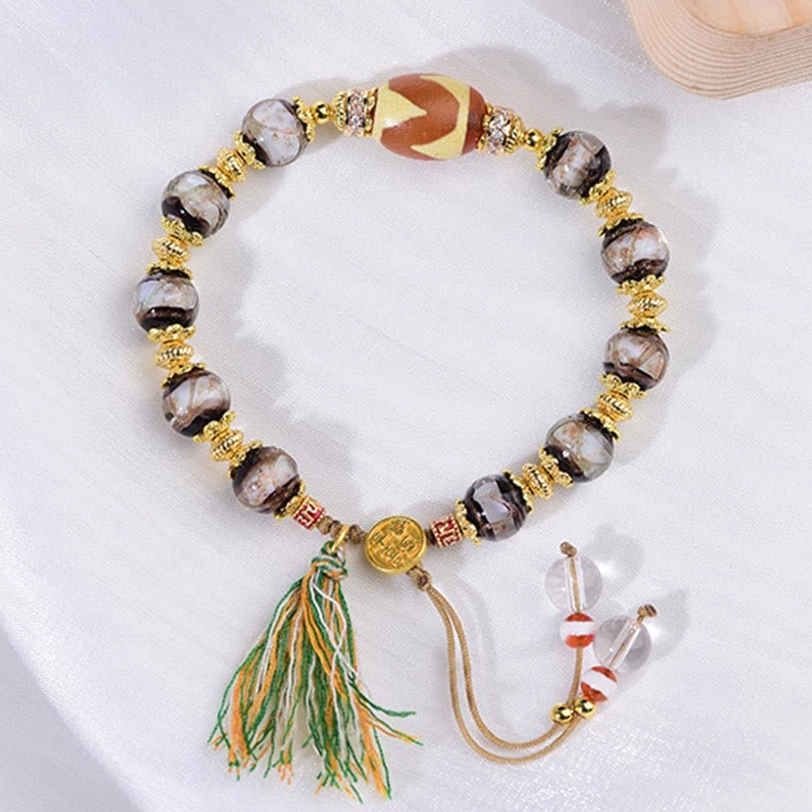 Tibetan Dzi bead bracelet showing color variations in Liuli glass beads and authentic bead patterns