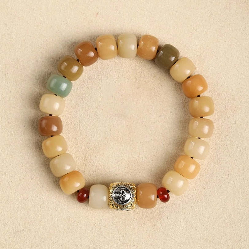Lord of the Corpse Forest bodhi seed bracelet, flat lay overhead view with gradient earthy beads and metal focal charm accent
