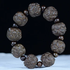 Lotus flower engraved ebony wood bracelet displayed flat showing detailed hand-carved lotus bead designs