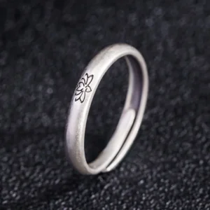 Adjustable lotus engraved silver ring profile side view showing matte finish and open band design