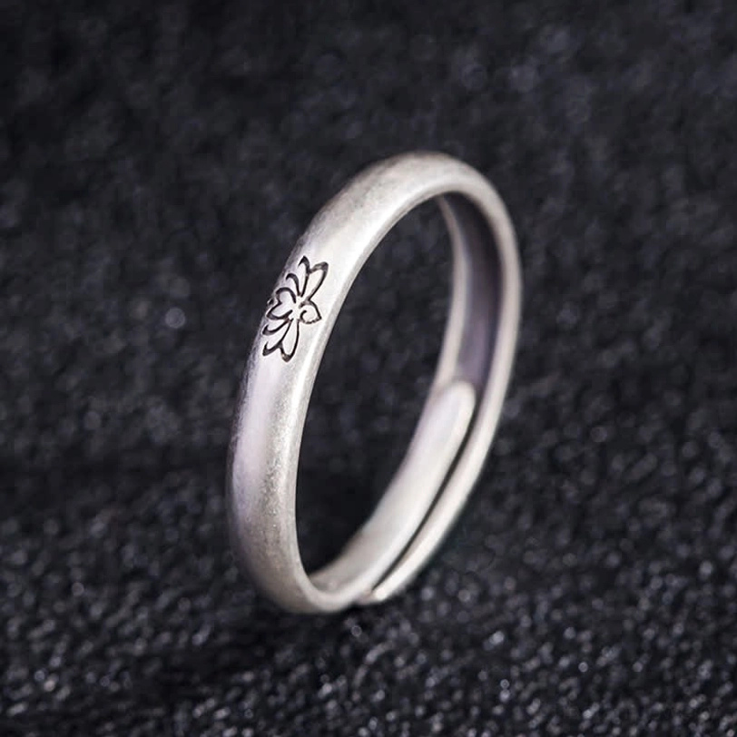 Adjustable lotus engraved silver ring profile side view showing matte finish and open band design