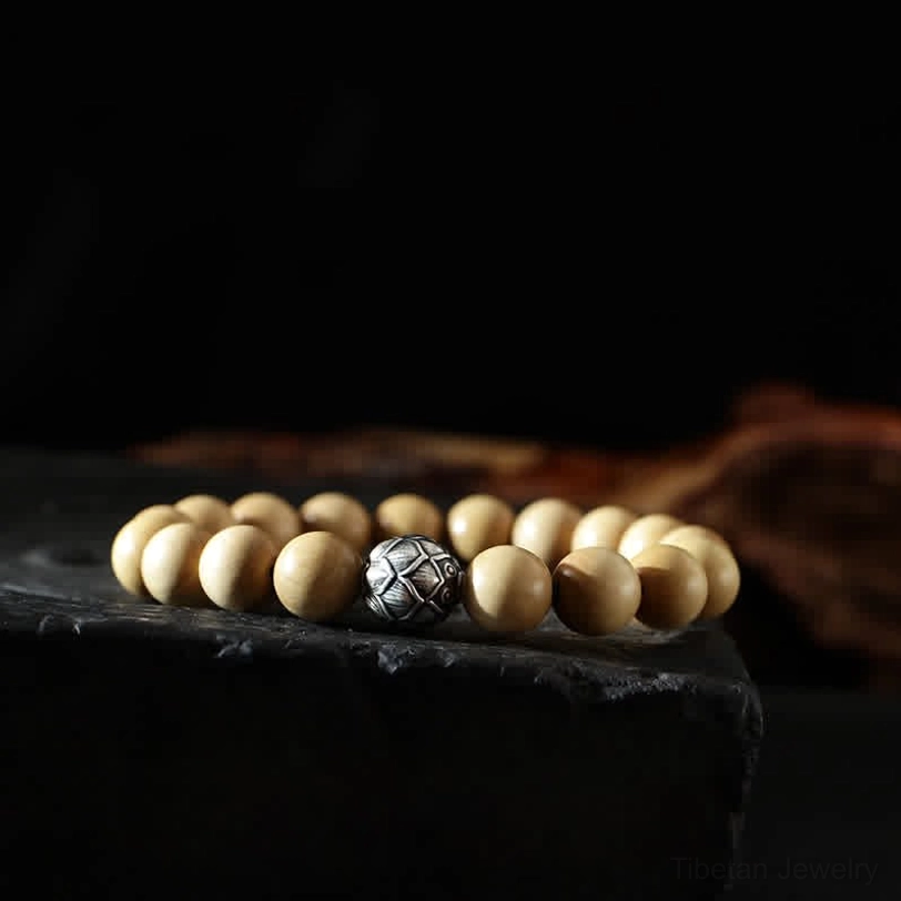 Lotus flower bracelet with handcrafted peach wood beads and silver engraved spacer - still life photography