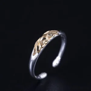 Tibetan lotus rebirth ring side profile showcasing polished silver band with gold lotus motif
