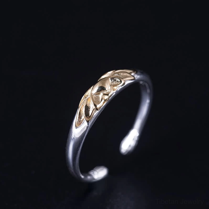 Tibetan lotus rebirth ring side profile showcasing polished silver band with gold lotus motif