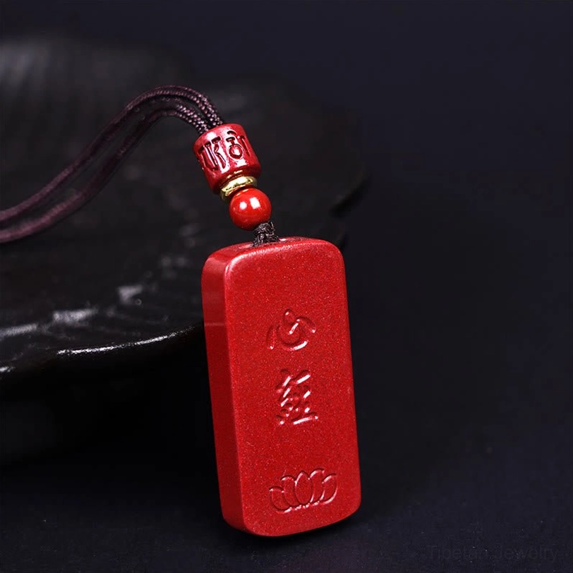 Lotus Heart Sutra engraved cinnabar necklace pendant detailed carving showing Buddhist wisdom text and lotus flower symbol