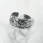 999 Sterling Silver Lotus Heart Sutra open adjustable ring with embossed lotus flower pattern, front oblique view on white fabric background