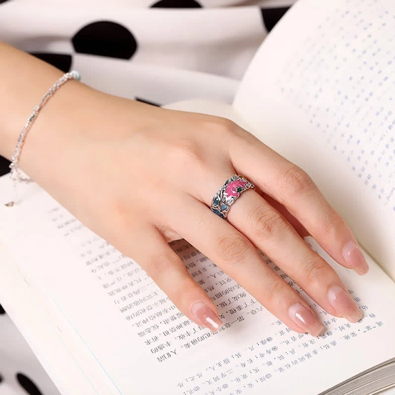 Lotus koi fish sterling silver ring worn on finger during reading, showing natural fit and comfortable wear