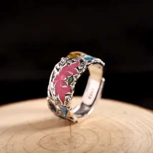 Lotus koi fish sterling silver ring with embossed design on wooden display stand, showing detailed craftsmanship and enamel accents
