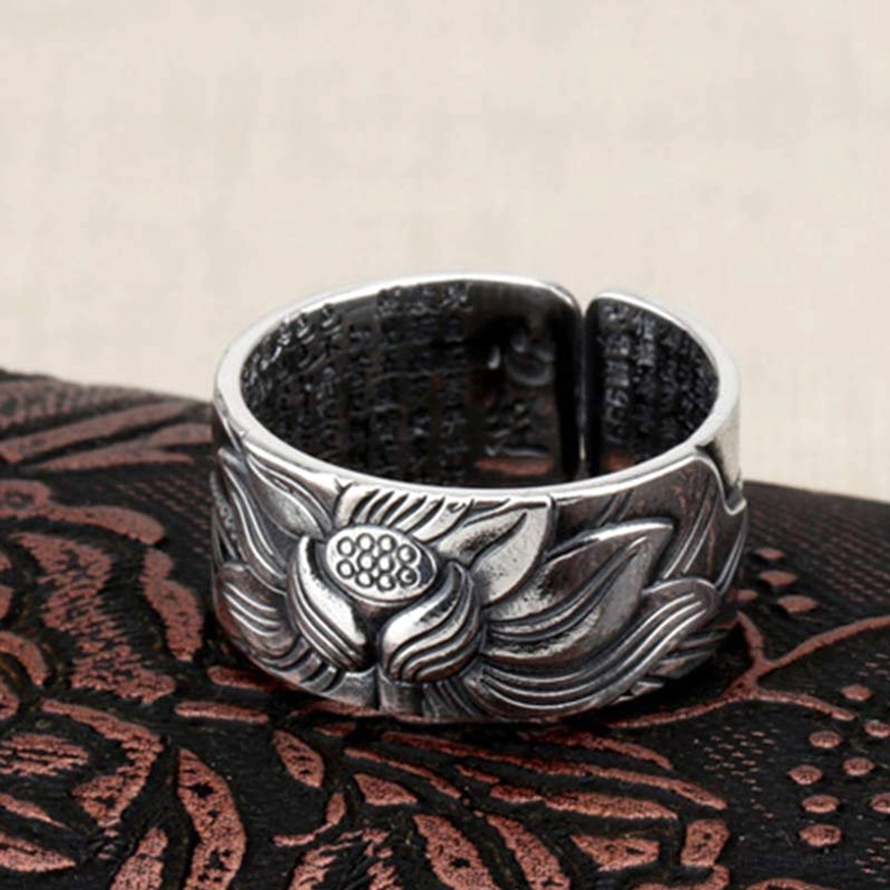 999 Sterling Silver lotus heart sutra ring with entire Heart Sutra text engraved on inner band, top view showing full carved lotus design