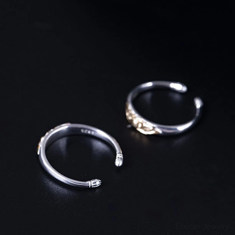 Two styles of 925 sterling silver lotus rings flat lay comparison one with gold lotus one with bud end tips