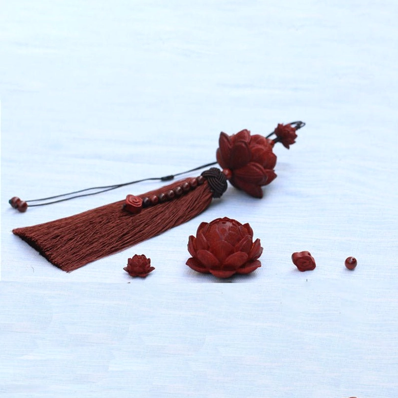 Tibetan lotus tassel decoration showcasing spare wooden lotus charm crafts and decorative beads on light blue fabric